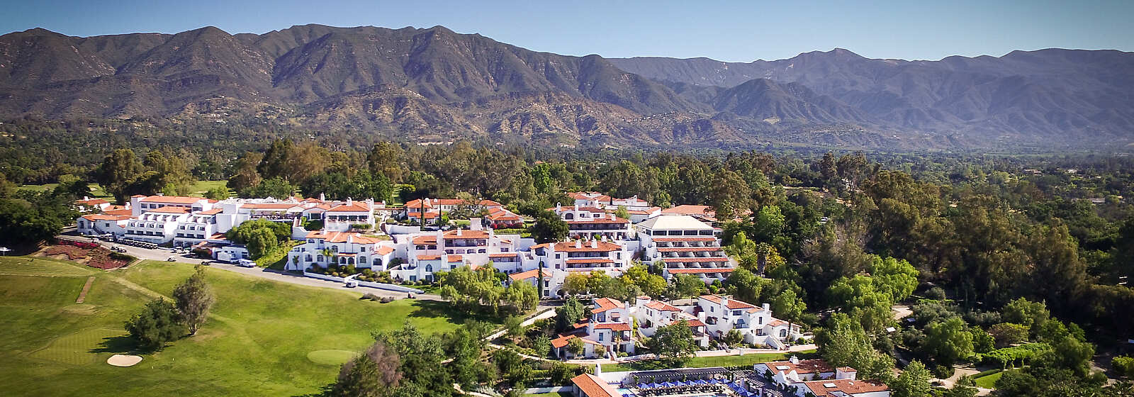 Aerial of the Ojai Valley Inn & Spa resort with the Topa Topa Mountains behind